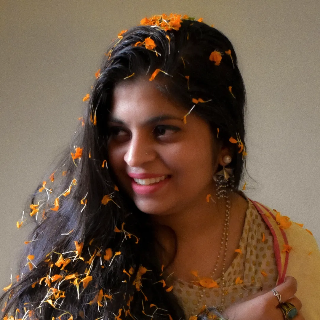smiling woman with flower garland around her head