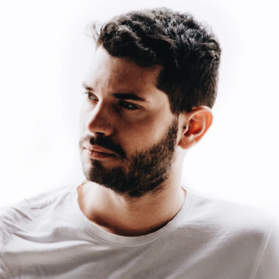 a man with a beard and a white shirt